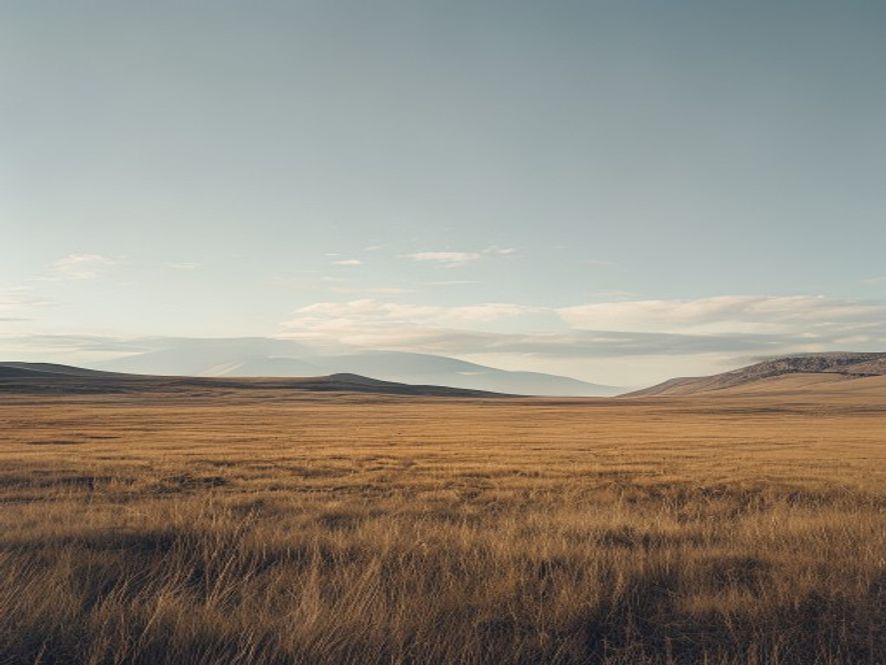 Expansive moorland trail stretching into distant hills under partly cloudy skies